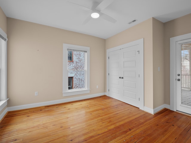 unfurnished bedroom featuring baseboards, visible vents, ceiling fan, access to exterior, and light wood-type flooring