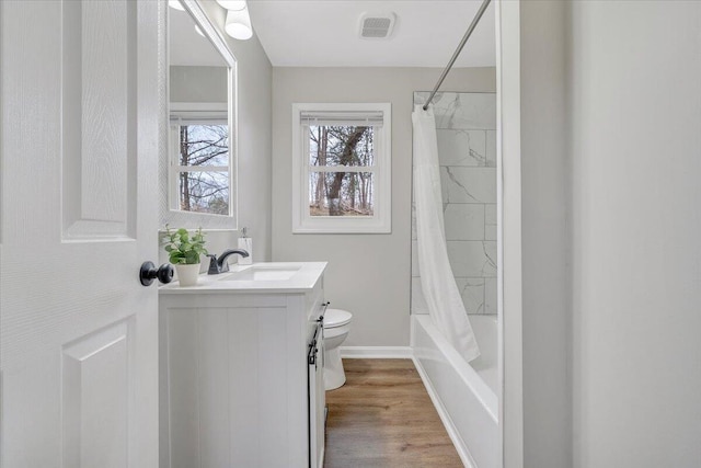 bathroom with visible vents, toilet, wood finished floors, shower / bath combination with curtain, and vanity