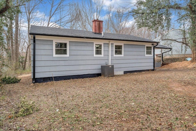 back of property featuring crawl space, central air condition unit, and a chimney