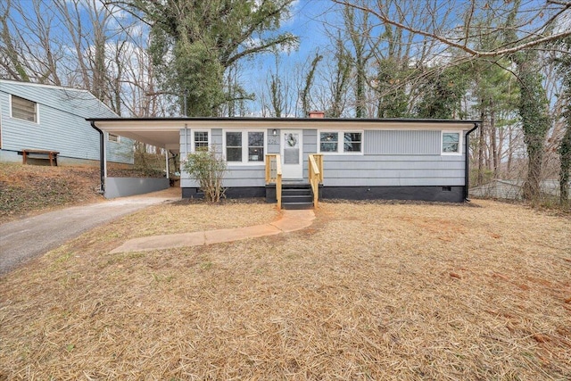 single story home featuring a carport, driveway, and crawl space