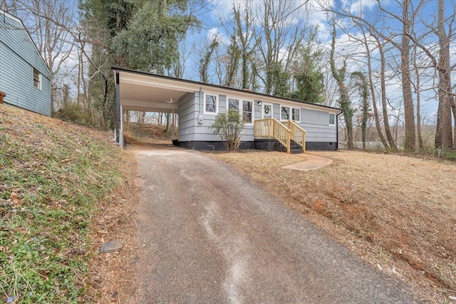 manufactured / mobile home with an attached carport, driveway, and crawl space