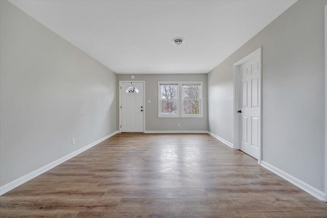 foyer with visible vents, baseboards, and wood finished floors