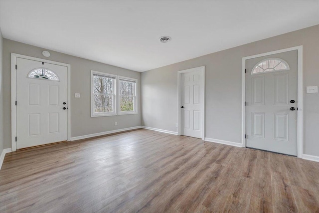 foyer with visible vents, baseboards, and wood finished floors