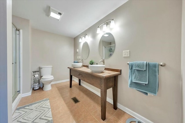 full bath with baseboards, toilet, tile patterned flooring, an enclosed shower, and a sink