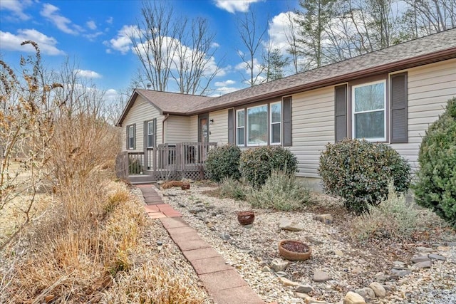 ranch-style home with a shingled roof