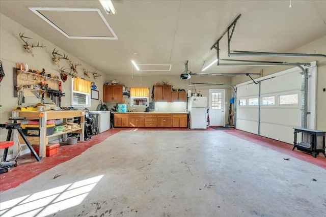 garage featuring a garage door opener, freestanding refrigerator, and a workshop area