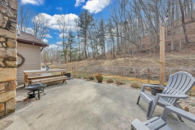 view of patio / terrace with an outdoor fire pit and fence