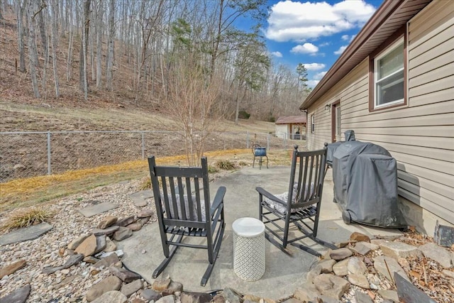 view of patio / terrace featuring a grill and fence