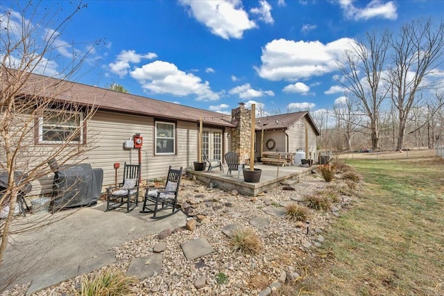 rear view of property featuring a patio area