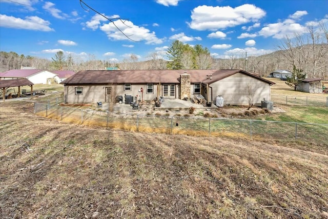 back of house with a patio, french doors, and a fenced backyard