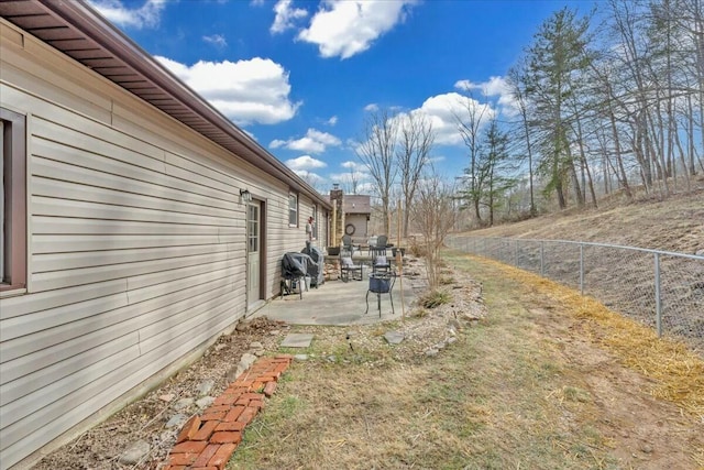 view of yard with fence and a patio