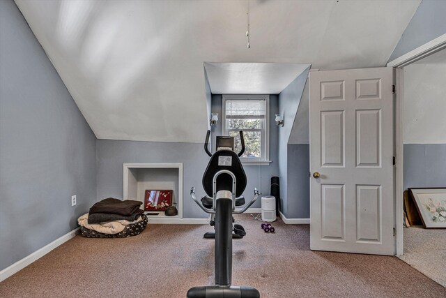 exercise room featuring carpet floors, lofted ceiling, and baseboards