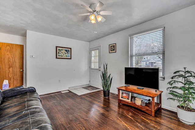 living room featuring ceiling fan, wood finished floors, and baseboards