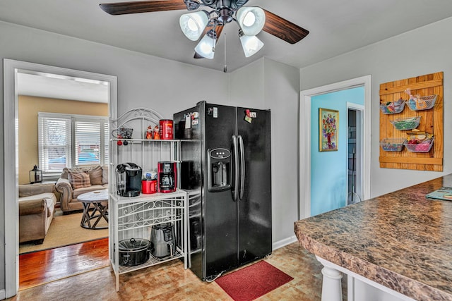 kitchen featuring black refrigerator with ice dispenser and a ceiling fan