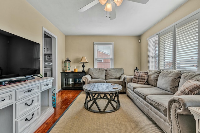 living area with dark wood finished floors and ceiling fan