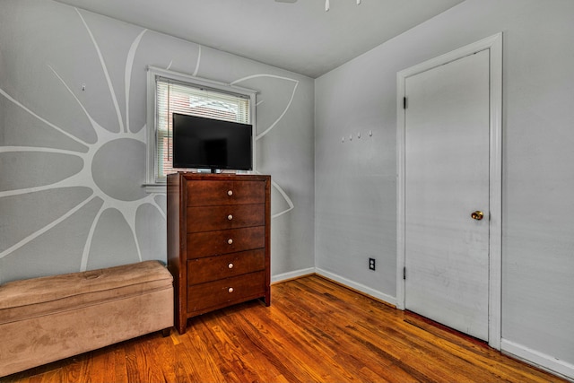 interior space featuring baseboards and wood finished floors