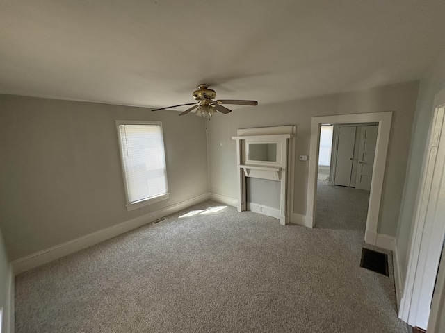 unfurnished bedroom featuring visible vents, a ceiling fan, baseboards, and carpet floors