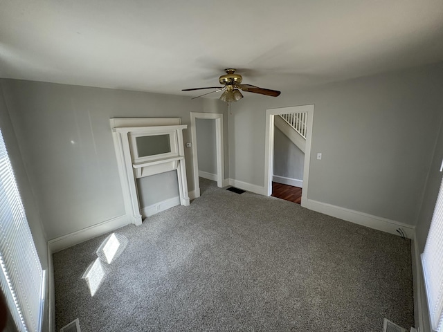 unfurnished bedroom with visible vents, carpet, baseboards, and ceiling fan