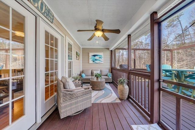 sunroom featuring ceiling fan