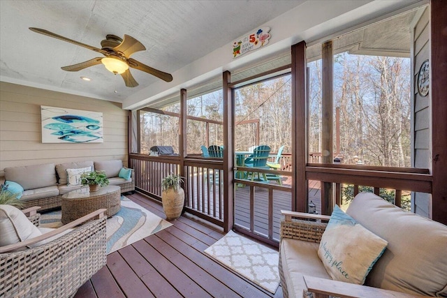 sunroom featuring ceiling fan