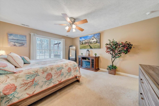 bedroom with baseboards, carpet flooring, arched walkways, a textured ceiling, and a ceiling fan