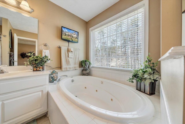 full bathroom with vanity and a whirlpool tub