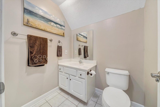 bathroom with baseboards, toilet, lofted ceiling, tile patterned floors, and vanity