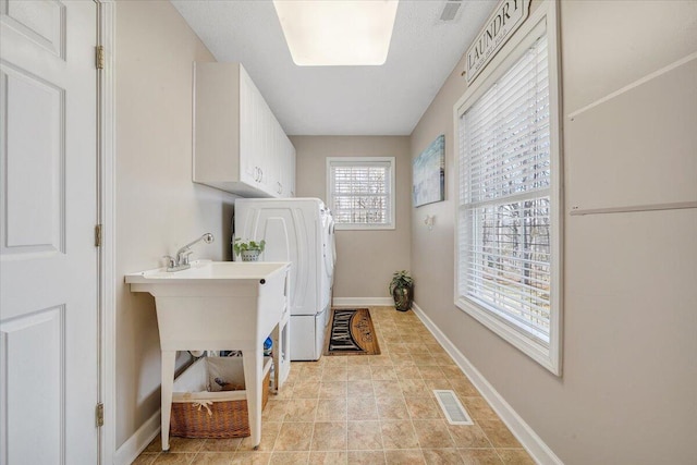 laundry room with washer / dryer, cabinet space, visible vents, and baseboards