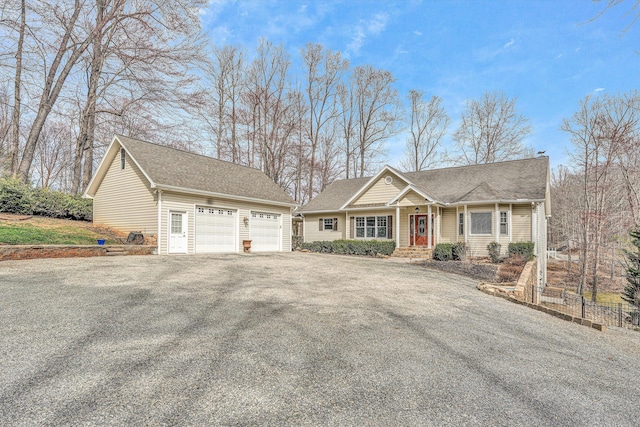 view of front of property with a detached garage and an outbuilding