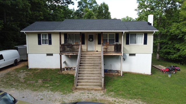 single story home featuring stairway, roof with shingles, covered porch, a chimney, and a front lawn