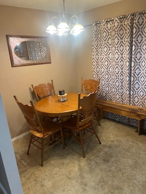 dining area with an inviting chandelier