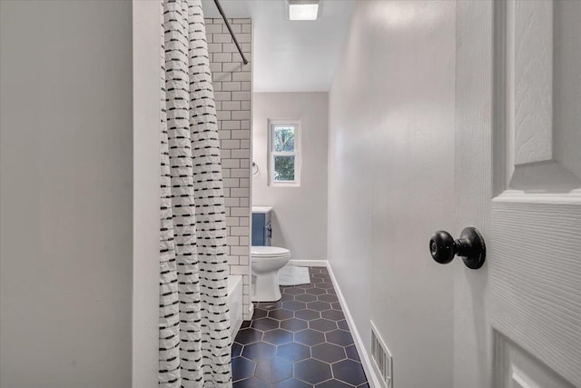 bathroom with tile patterned floors, visible vents, toilet, baseboards, and walk in shower