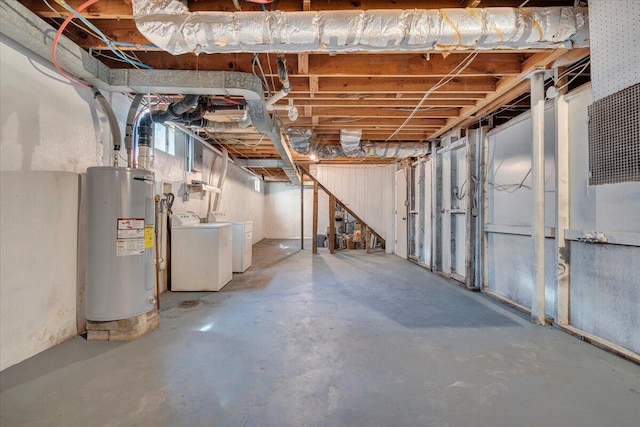 unfinished basement featuring washer and dryer and electric water heater