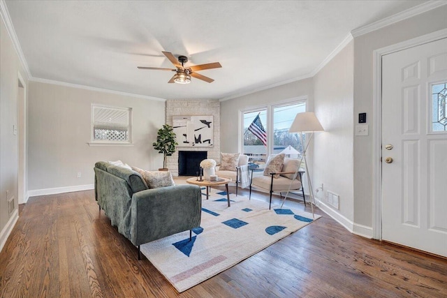 living area featuring visible vents, a brick fireplace, crown molding, and wood finished floors