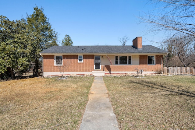 ranch-style house with brick siding, a chimney, a front yard, and fence