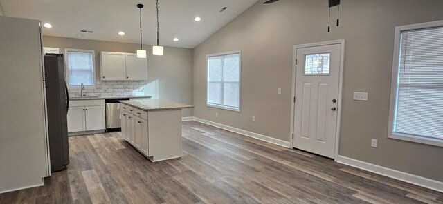 216 Franklin Ave, Vinton, VA 24179 - kitchen featuring freestanding refrigerator, dishwasher, a kitchen island, white cabinets, and backsplash