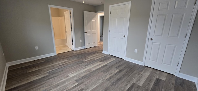 216 Franklin Ave, Vinton, VA 24179 - unfurnished bedroom featuring dark wood-style flooring and connected bathroom