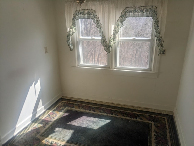 unfurnished room featuring baseboards