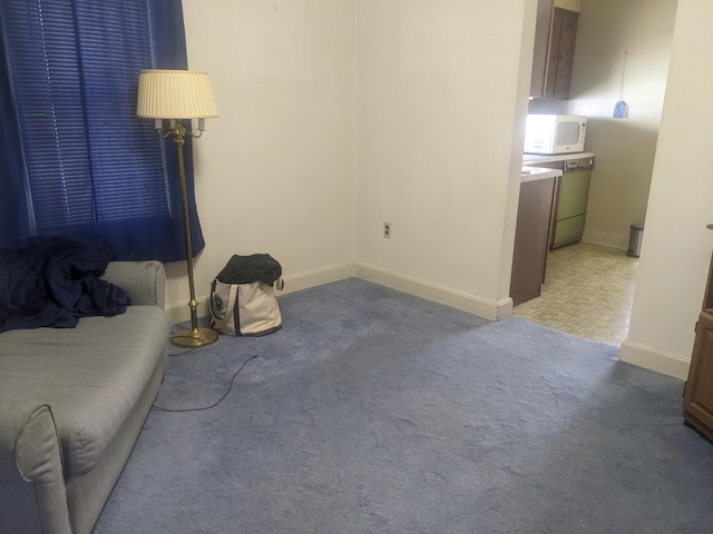 living room with carpet and baseboards