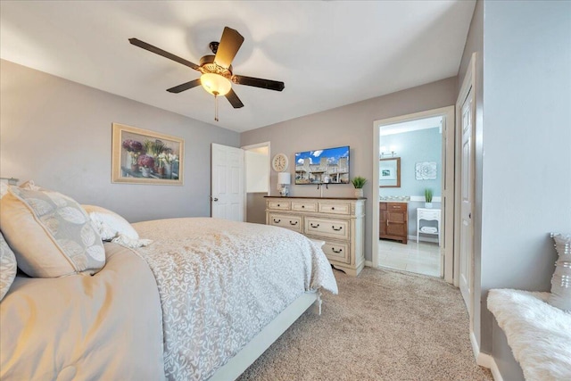 bedroom with light carpet, a ceiling fan, and ensuite bathroom