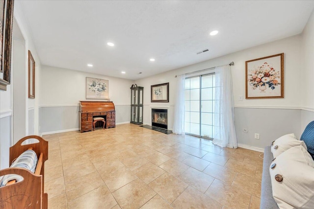 living area with recessed lighting, visible vents, baseboards, and a fireplace