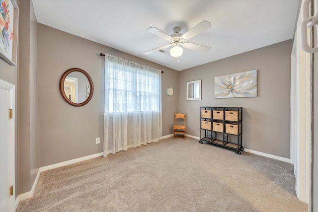 unfurnished room featuring baseboards, carpet floors, and ceiling fan