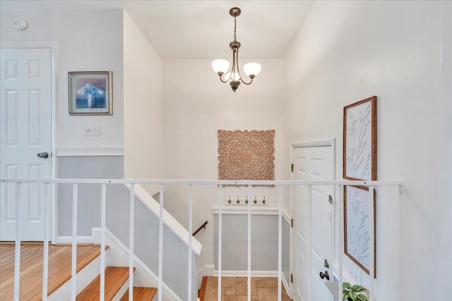 staircase with a chandelier