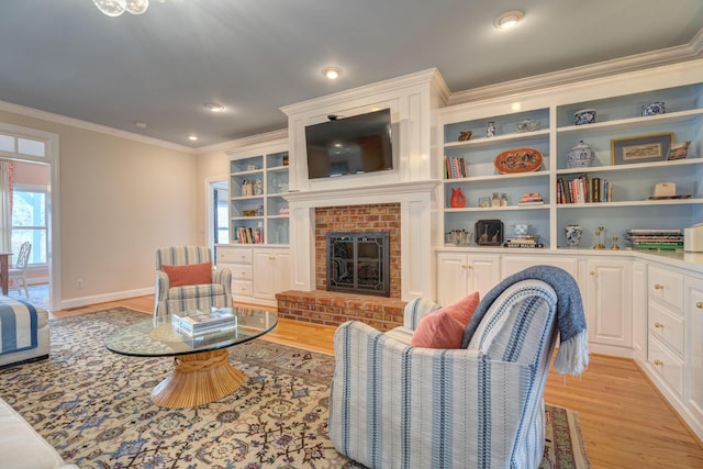 living room with light wood-style flooring, a brick fireplace, baseboards, and ornamental molding