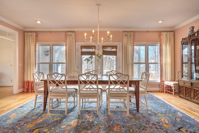 unfurnished dining area featuring ornamental molding, wood finished floors, baseboards, and a chandelier