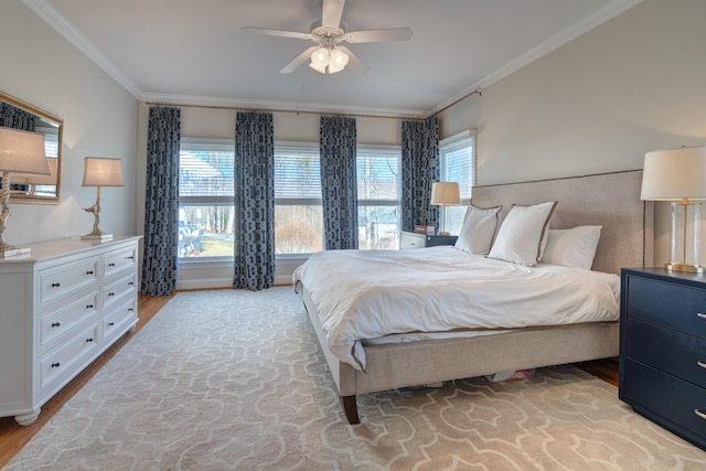 bedroom with a ceiling fan, crown molding, and wood finished floors