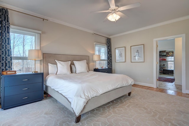 bedroom featuring light wood-type flooring, multiple windows, and crown molding