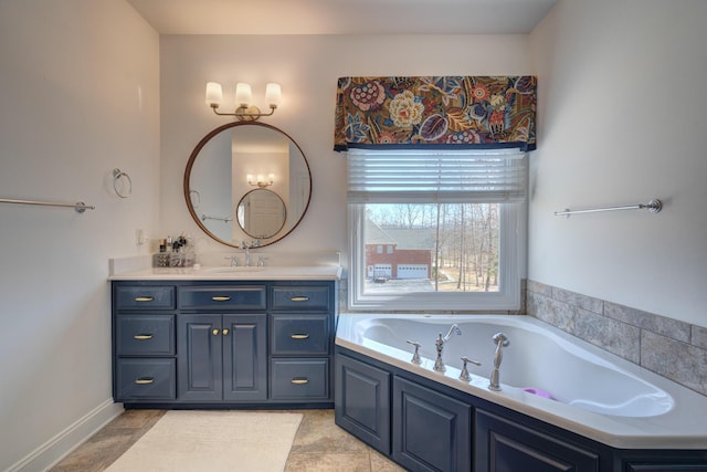 full bath with vanity and a garden tub