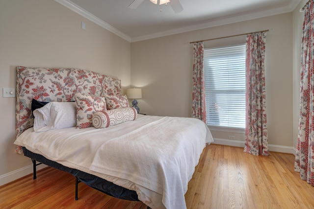 bedroom with baseboards, wood finished floors, a ceiling fan, and ornamental molding