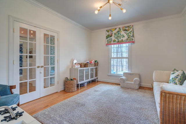 sitting room featuring french doors, wood finished floors, baseboards, and ornamental molding